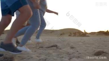 斯坦尼康慢动作拍摄的腿，四个人跑在一排，它发生在海滩上